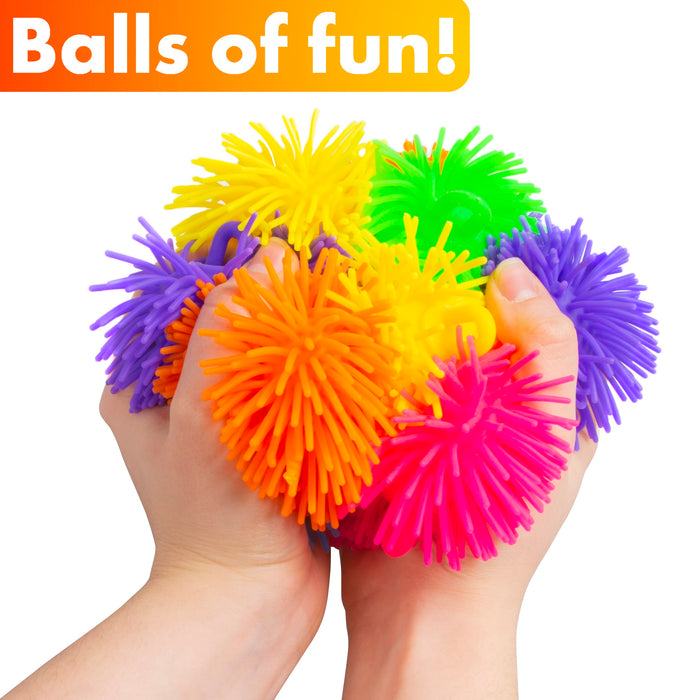 Two hands squeezing a cluster of colorful spiky stress balls, including orange, pink, yellow, green, and purple, with an orange banner at the top reading 'Balls of fun!'.