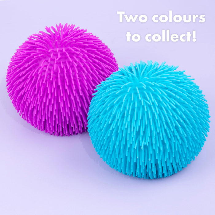 Two textured, spiky squeeze balls in bright magenta pink and cyan blue on a light lavender background, with the text 'Two colours to collect!' in the top right corner.