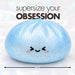 Giant 17cm squishy dumpling out of its steamer box showing the size of the dumpling.
