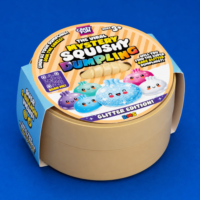 The Viral Mystery Squishy Dumpling Glitter Edition 17cm, shown in its cardboard packaging on a solid blue background.