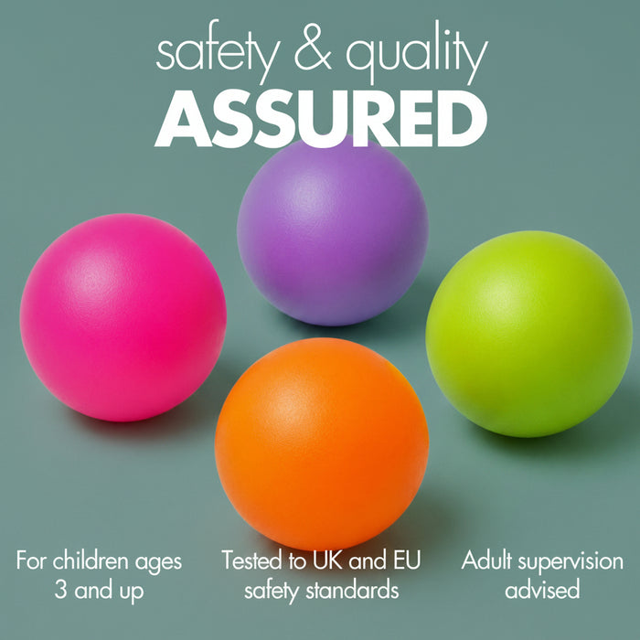 Four smooth plastic balls in pink, purple, orange, and green on a light aqua background with the text 'safety & quality ASSURED' and smaller feature callouts. Fully tested to UK standards.
