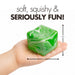 A hand holds a green and white marbled cube-shaped foam toy with arrows and text showing its dimensions as 6cm by 6cm by 6cm, on a white background.