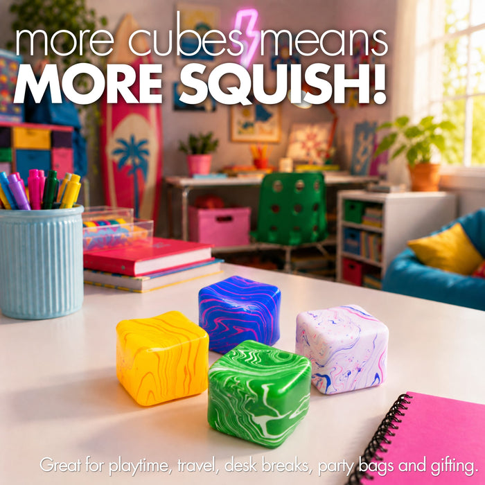Four colorful squishy stress cubes with marbled patterns in yellow, green, blue, and white, displayed on a white desk in a brightly lit, colourful playroom. 