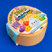 A round plastic toy container for 'The Original Viral Squishy Dumpling' by RMS, featuring a light peach-beige body with a colorful printed lid. The packaging includes a light blue side flap and shows cartoon dumpling characters on the top.