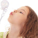 girl using party bubbles wand to blow bubbles  
