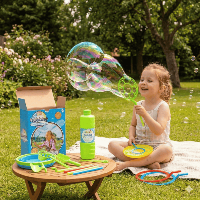 Child playing with bubble wand in a garden with bubble solution and giant bubble kit. 