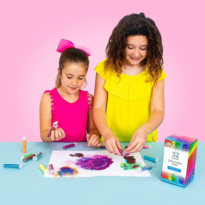 two girls playing with glitter shaker tubes